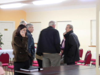 worried shell directors huddle inside the meeting hall