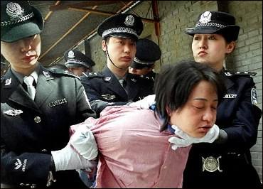 A woman is taken away for execution after being sentenced to death in Beijing in 2001