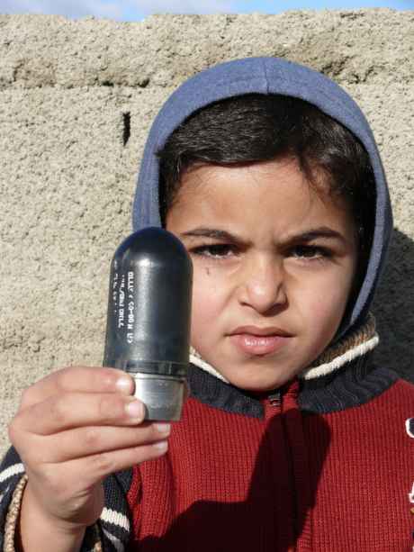 "The rocket" : new form of high velocity tear gas projectile but used by the IOF as a lethal weapon - the young lad holding the projectile is a son of Iyad Burnat, Head of the Bil'in Popular Committee