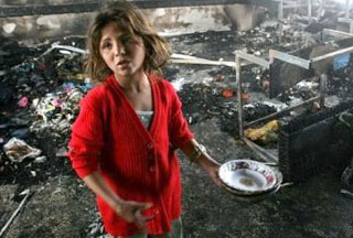 A Palestinian child seeking food in the ruins of what used to be her home