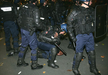 French police arrest a protester who was taking part in National Union demonstration against retirement reform in Paris last night. (Is France racist?)  
