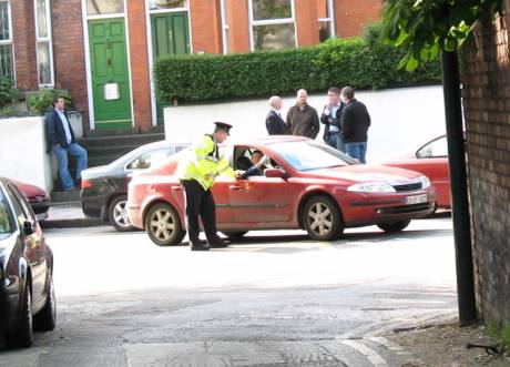 Gardai turn cars away as secret police look on