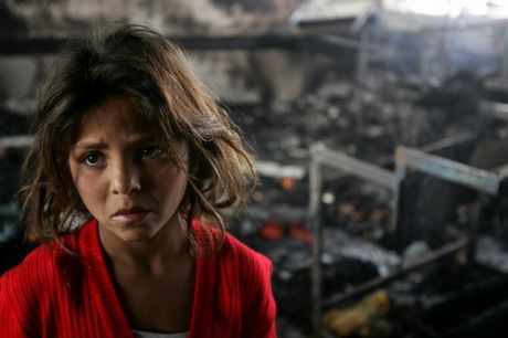 A homeless Palestinian girl stands in an incinerated  classroom at a UN school after it was deliberately shelled by Israeli invasion forces on January 17, 2009 in Beit Lahia, northern Gaza Strip.