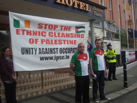 Cllrs Brady and Murray outside the hotel in Palestinian football jerseys