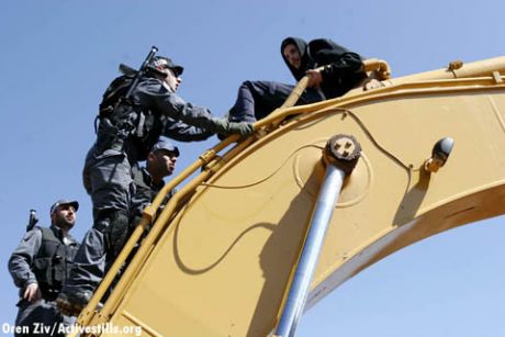 A demonstrator occupying a bulldozer