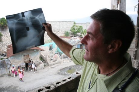 Fr Rick checks examines a chest x-ray in the clinic in the heart of Cit Soleil