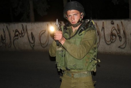 IDF Soldier points his gun at Bil'in based journalist