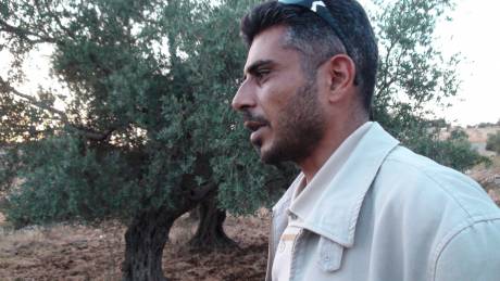 Iyad Burnat, head of Bil'in's Popular Committee surveys the damage