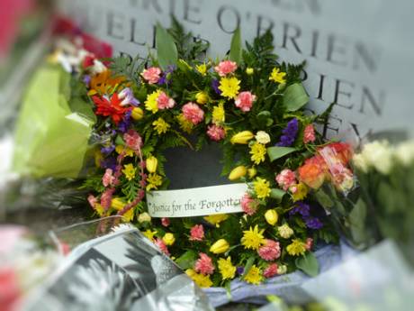 A closeup of some the flowers left at the foot of the Memorial