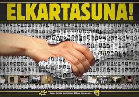 A poster of some of the 600 prisoners becomes a hand, gripping the hand of solidarity