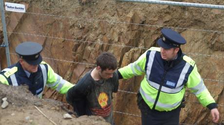 A brave young man is handcuffed and in the custody of Shell's criminals