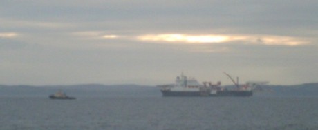 Solitaire was joined by tugs at sunset